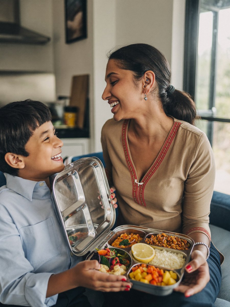 A South Indian mother and her son opening a SchooFoo lunchbox together